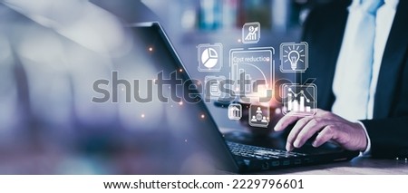 Cost reduction business finance concept on virtual screen. Costs reduction, costs cut, costs optimization business concept. Businessman draw simple graph with descending curve. Royalty-Free Stock Photo #2229796601