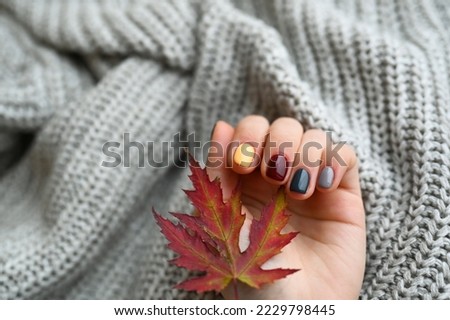 Women's hands with colorful pattern on the nails. Top view. Place for text.