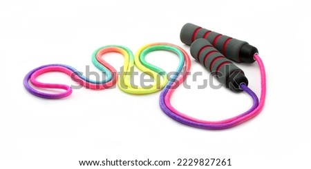 Jumping rope on a white background. Sports equipment jump rope for weight loss. Royalty-Free Stock Photo #2229827261