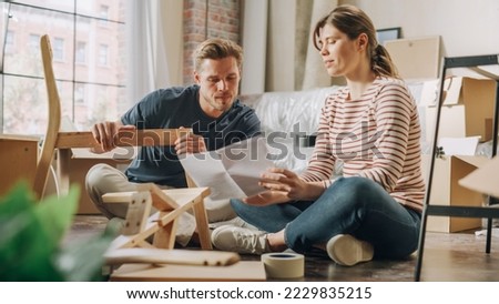 Family Moving in: Happy Couple Assembles Furniture Together, Girlfriend Boyfriend Do High Five after Successfully Doing the Job. Furniture Assembly in New Apartment for Young Partners in Love Royalty-Free Stock Photo #2229835215