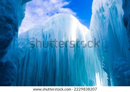 A beautiful view of huge ice formations against the blue sky with floating white clouds Royalty-Free Stock Photo #2229838207