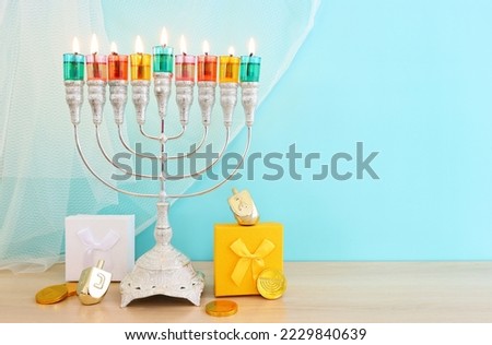 image of jewish holiday Hanukkah background of spinning tops with letters that mean, A GREAT MIRACLE HAPPENED HERE 