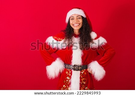 beautiful brazilian black woman, dressed as santa claus, christmas clothes. Hands on the waist half body photo