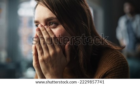 Sad Woman being Harrased and Bullied. Couple Arguing, Fighting, Domestic Violence, Abuse. Cinematic Rack Focus Switching Between Girlfriend Closeup Portrait and Boyfriend Screaming in Background Royalty-Free Stock Photo #2229857741