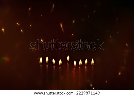 Religious image of Jewish holiday Hanukkah with candles of menorah with sparks from the fire in the air