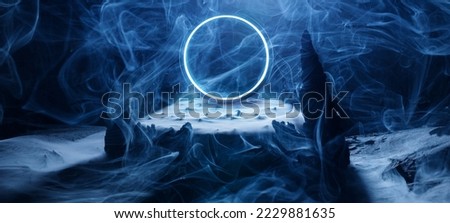 Neon blue color geometric circle. Rocks in smoke on a dark background. Panoramic view of the abstract fog. Mockup for your logo.