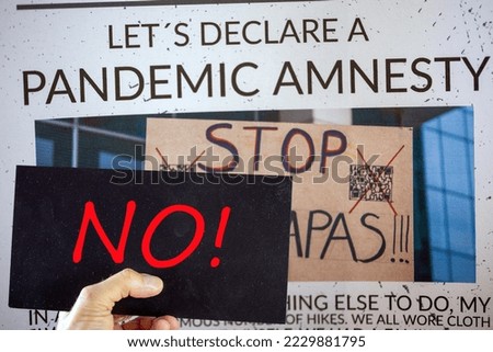Symbolic image Pandemic Amnesty: Cut-out of a symbolic newspaper, a sign with the inscription NO is held in front of it. The photo in the background of the image is by the compositor himself