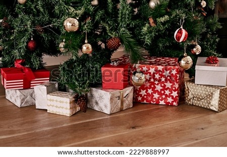 Christmas, floor and box of gift by tree for celebration, festive season and party. Xmas, surprise and gratitude with present on ground of living room with nobody for wow, announcement and holiday