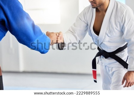 Karate, fighting tournament and men fist bump in martial arts competition for fighters with sportsmanship, honor and discipline. Man, judo fighters and self defense fight to win in dojo with respect Royalty-Free Stock Photo #2229889555