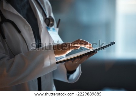 Telehealth, digital tablet and doctor hands for hospital innovation, software management and results update in dark workplace. Healthcare, cardiology and telecom medical professional with technology Royalty-Free Stock Photo #2229889885