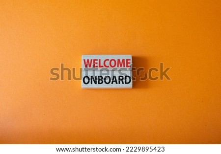 Welcome onboard symbol. Concept words Welcome onboard on wooden blocks. Beautiful orange background. Business and Welcome onboard concept. Copy space.