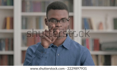 Young African Man Pointing at the Camera