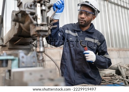Portrait African American engineer work with machine at lathe factory	