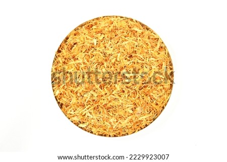 Top view of dried healthy organic calendula flowers coarse cuts isolated on white background. herbal tea ingredients. Dehydrated calendula pieces. Dried calendula flowers pile. Dry marigold petals.