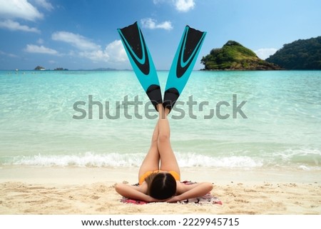 Asian lady in bilini relax wit fins and sleep on the beach in summer time at Koh Kood, Thailand Royalty-Free Stock Photo #2229945715