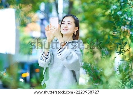 young woman holding smartphone up