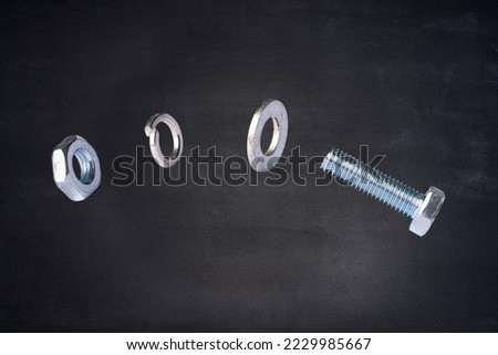 Screws and nut on the dark background.