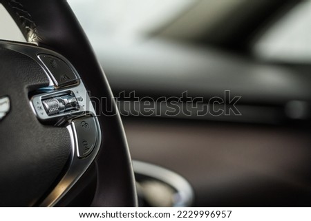 Cruise control switch closeup. Adaptive cruise control leaver. Cruise control on steering wheel. Royalty-Free Stock Photo #2229996957