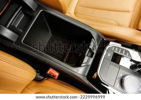 Car armrest opened. Opened armrest in the car for driver. Royalty-Free Stock Photo #2229996999