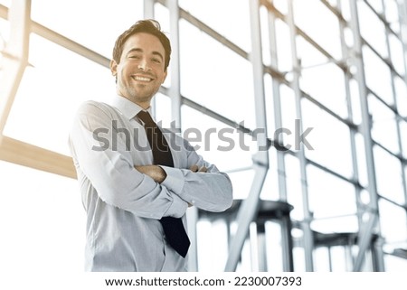 Doing business with the right attitude. Cropped portrait of a businessman standing in the lobby. Royalty-Free Stock Photo #2230007393