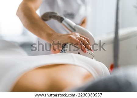 closeup view of a professional giving a client anti-cellulite massage at the cosmetology center, beauty treatment concept. High quality photo