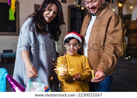 Posada, Mexican family with child with sparklers and Singing carols in Christmas party in Mexico Latin people