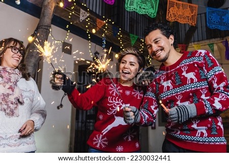 Posada Mexicana, Mexican couple or friends Singing carols with sparklers in Christmas in Mexico	