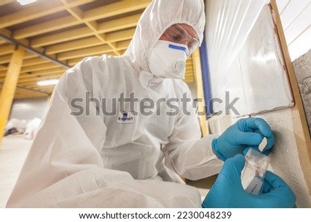 Asbestos surveyor taking a sample of building material, detection of asbestos, in accordance with the recommendations of standard NF X 46-020 Royalty-Free Stock Photo #2230048239