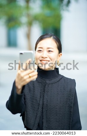 Woman looking at smartphone screen   