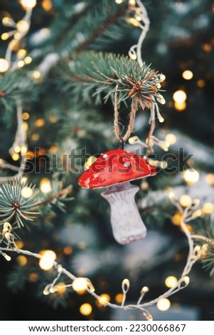 Diy pottery toy on Christmas tree. Fly agaric bauble sustainable Christmas tree decoration. Christmas zero waste Royalty-Free Stock Photo #2230066867