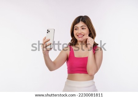 Portrait of happy smiling young woman selfie with smartphone isolated over white background. Technology, people and lifestyle concept.