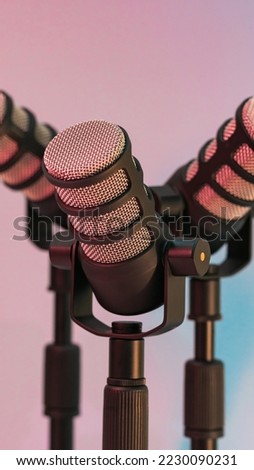 Microphone for podcasts and studio on a blue background and pink mat