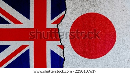 British and Japanese flags on broken cracked wall.