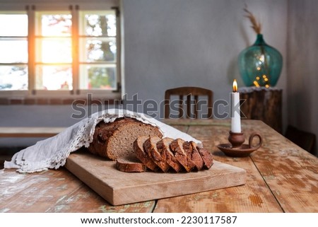 Homemade bread on rustic wooden table in Hellenurme watermill, Estonia Royalty-Free Stock Photo #2230117587