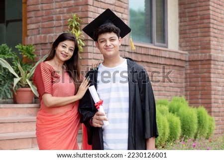 Indian university male student and proud mother celebrating graduation degree convocation ceremony Royalty-Free Stock Photo #2230126001