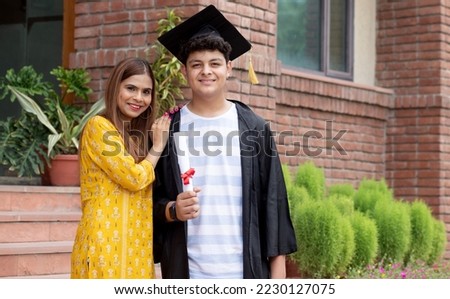 Indian university male student and proud mother celebrating graduation degree convocation ceremony Royalty-Free Stock Photo #2230127075