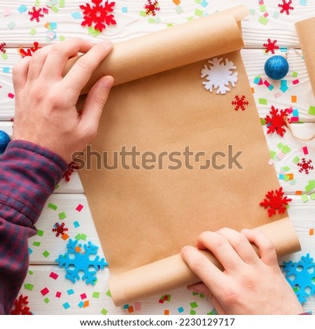 man holding a wishlist on the background of snowflakes