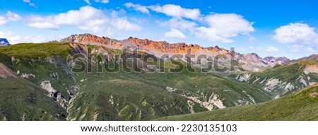 Banded red rock of Red Castle Ridge alpine mountain tundra wilderness landscape panorama in Kluane National Park near Silver City, western Yukon Territory, YT, Canada Royalty-Free Stock Photo #2230135103