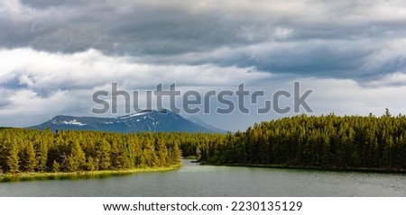 Bad weather clouds over Snafu Lake boreal forest taiga landscape in Agay Mene Territorial Park, Yukon Territory, YT, Canada Royalty-Free Stock Photo #2230135129