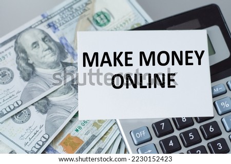 make money online word on a card on the background of a calculator and dollar money on the table, a business concept