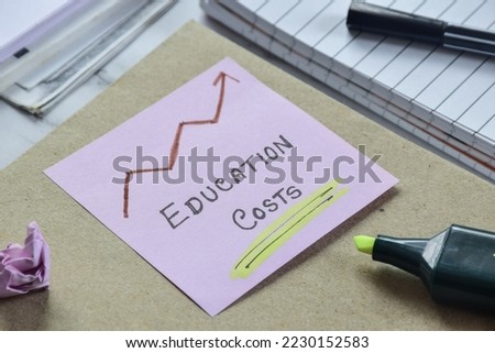 Increasing education costs concept on study desk. Selective focus. Royalty-Free Stock Photo #2230152583