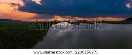 Panorama mountains view with sunset over sea surface water background,Amazing sea sun reflections,Aerial view over mountains view,Amazing sunrise light in dramatic sky 