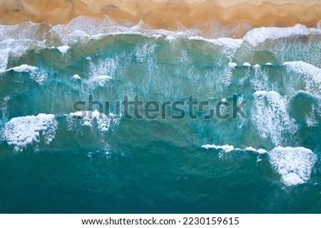 Aerial view of sea crashing waves White foaming waves on beach sand, Top view beach seascape view Nature sea ocean background