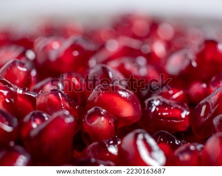 Ripe pomegranate. Fresh juicy pomegranate seeds on a light background. Close-up.