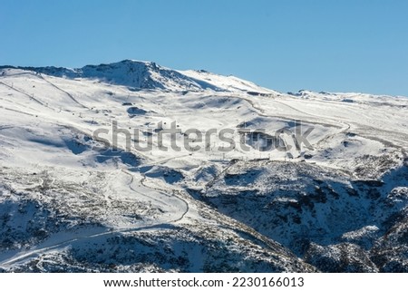 panoramic view of ski resort in sierra nevada, skiers along the slopes,