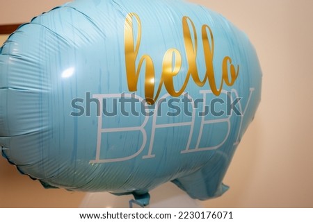 blue balloon, on the occasion of the birth of a child near the children's bed, a symbol of happy childhood, birthday, festive decoration, close up