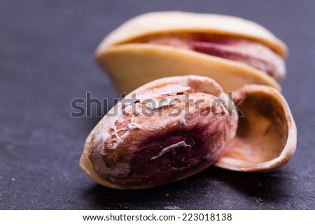 Peeled peanuts on well peanuts in background. Macro image 
