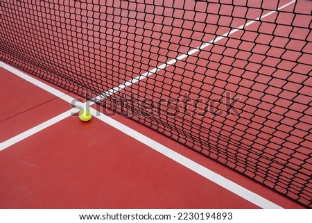 a ball near the net of a tennis court