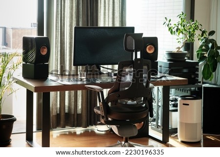 Home office desk with computer monitor and ergonomic chair. Royalty-Free Stock Photo #2230196335
