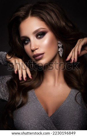 Beautiful woman with professional make up and curly hair